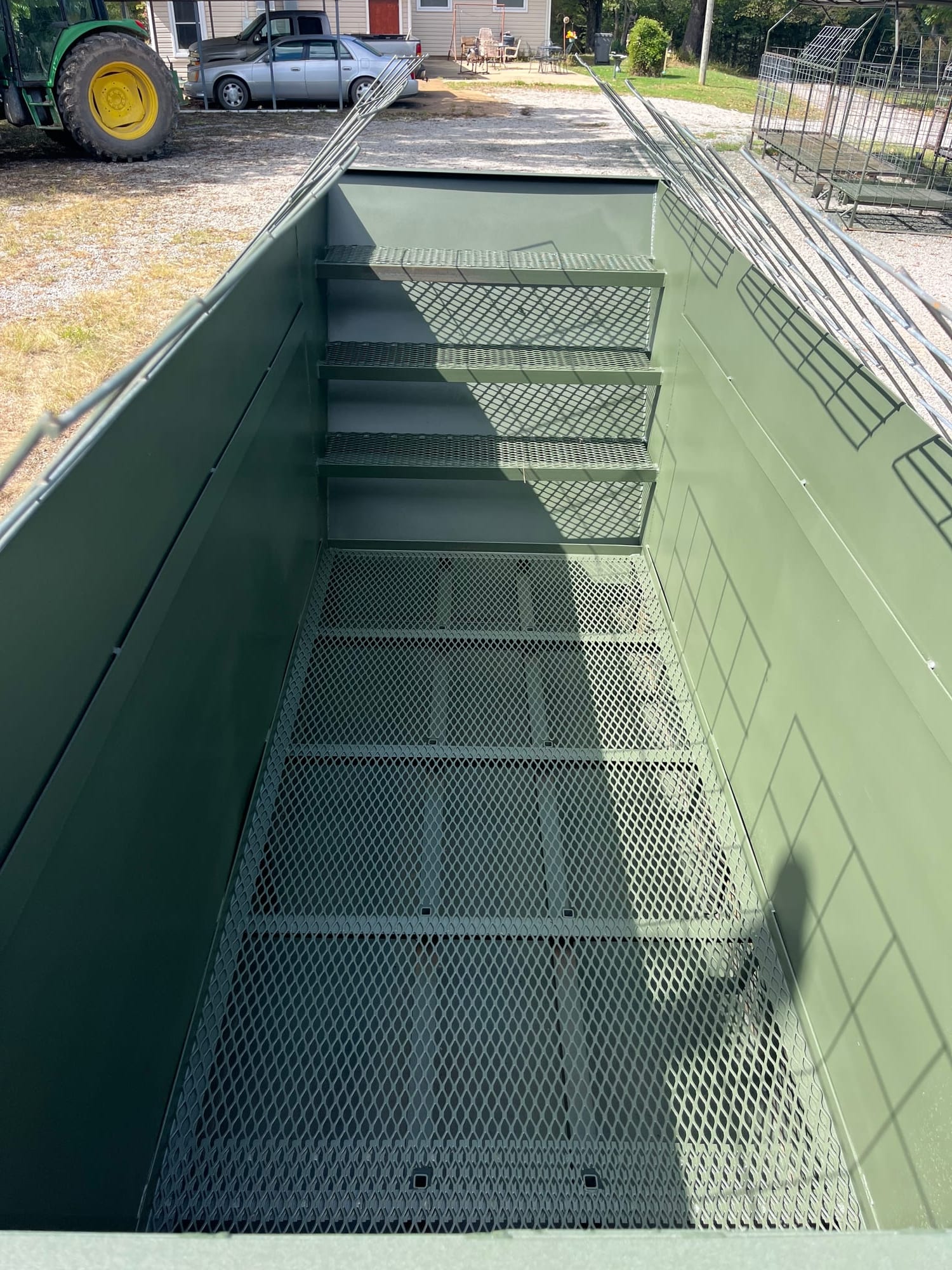 Long interior view of pit blind showing expanded metal panels and seating mounts