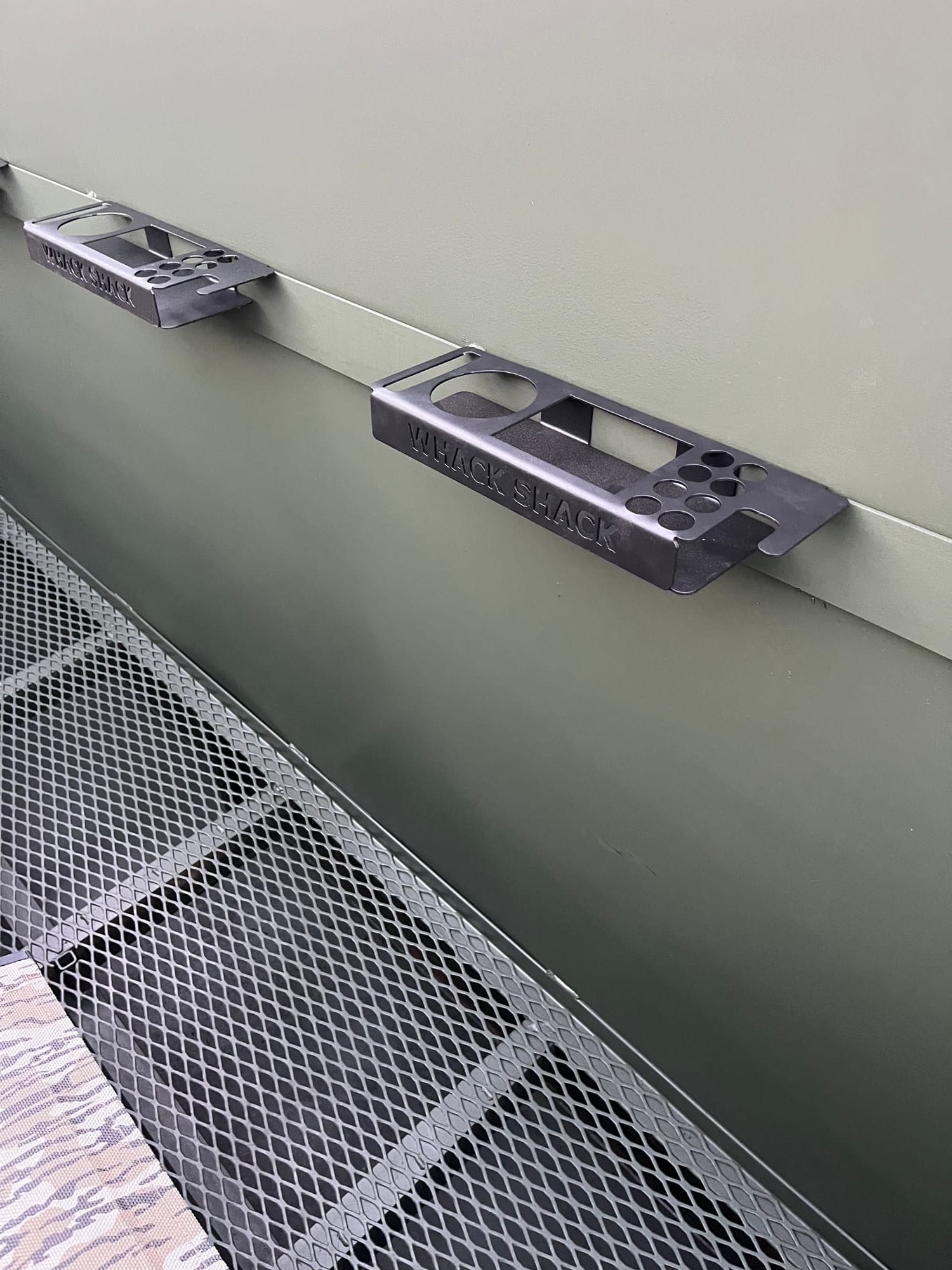 Whack Shack branded steel gun holders inside a pit blind