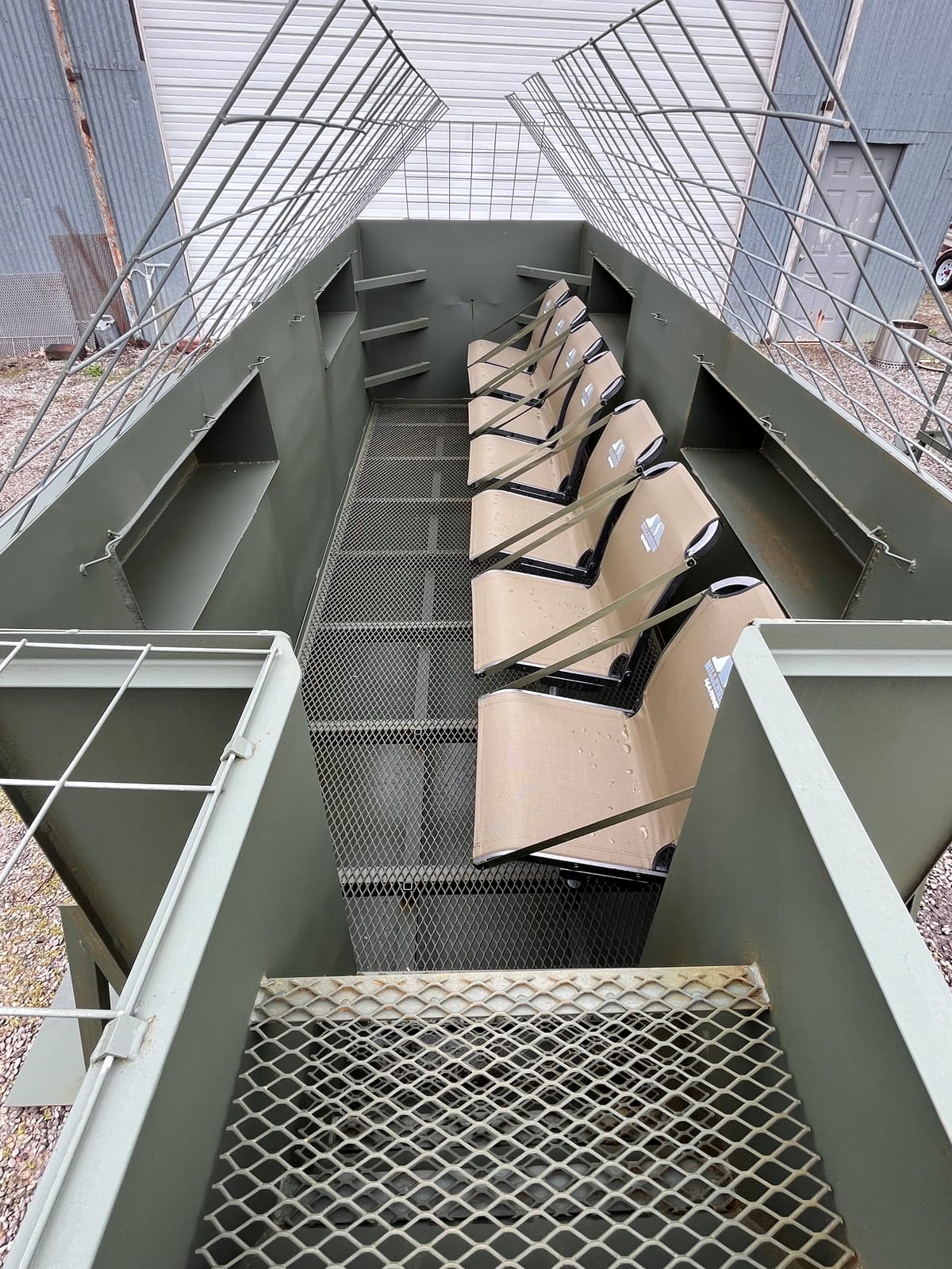 Inside view of a custom steel duck blind — comfortable seating and layout