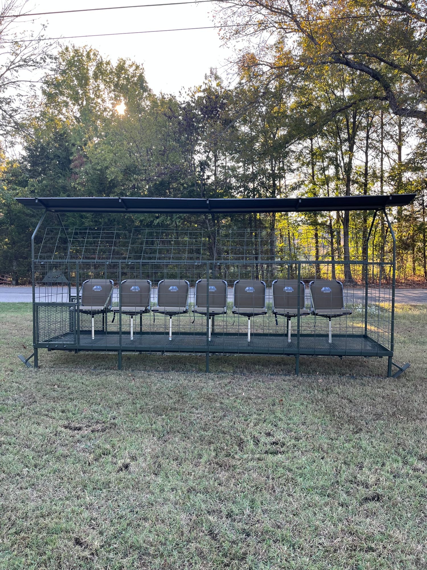 Full-length side view of a steel skid blind with seats