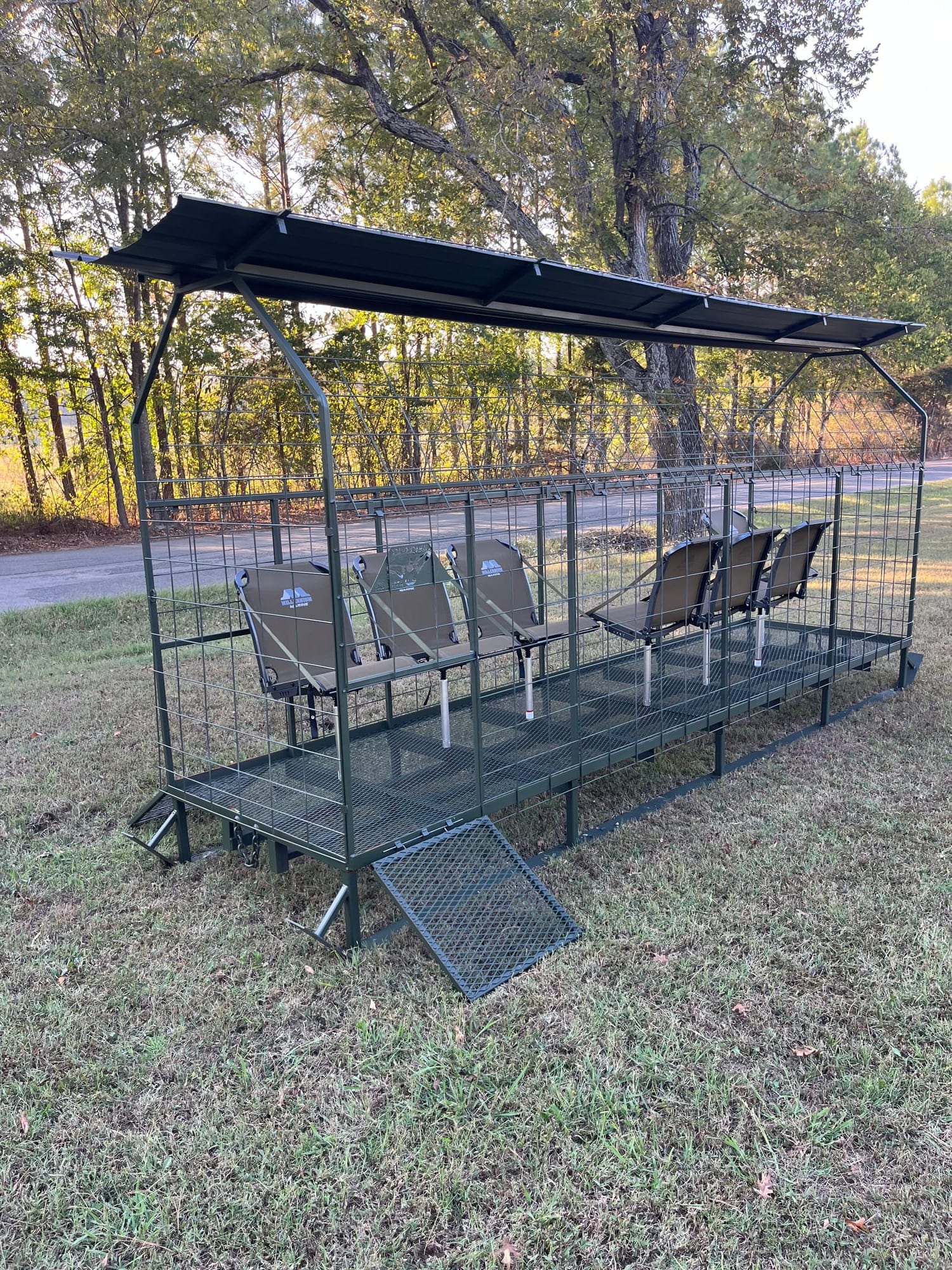 Long side view of portable skid blind with seating and skid rails
