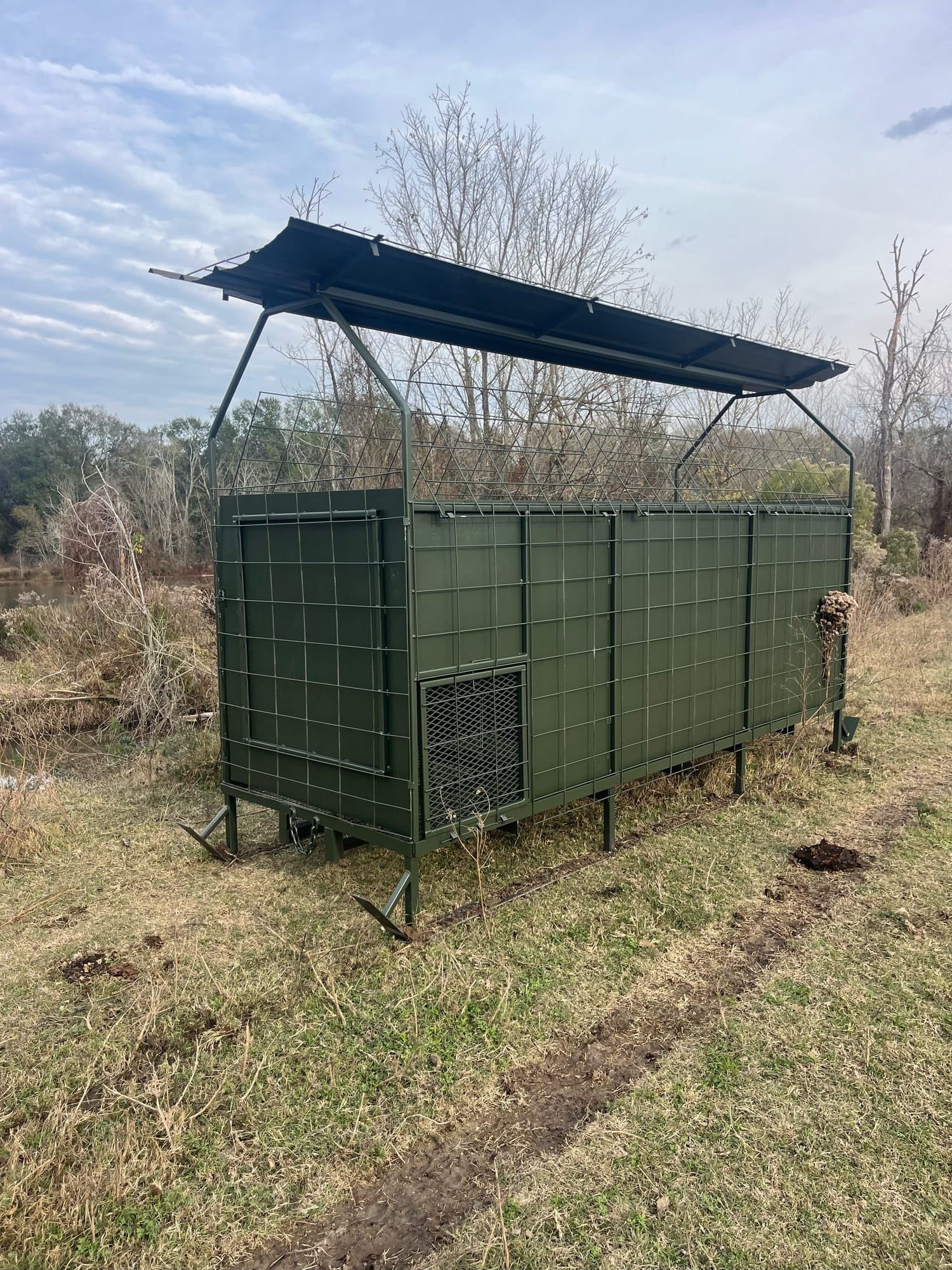 Green steel skid blind exterior with closed panels and skid rails